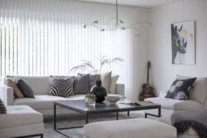 Modernt vardagsrum med lamellgardiner som ger effektiv ljusreglering och insynsskydd.